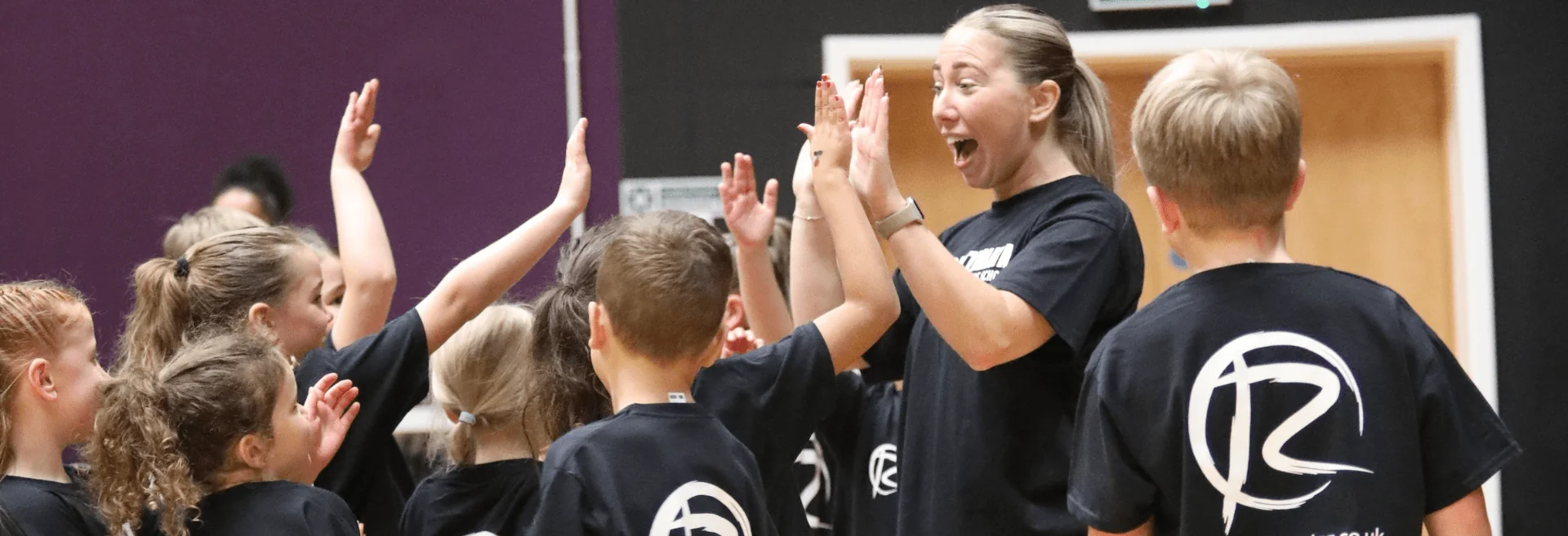 Students giving high fives to their teacher