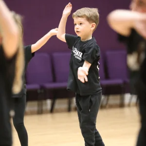 Boy waving his arms in a dance class