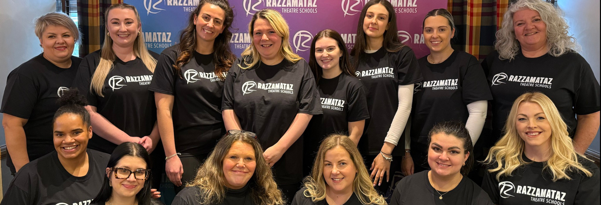 Franchisees in attendance to the Razzamataz conference smiling in their new t-shirts
