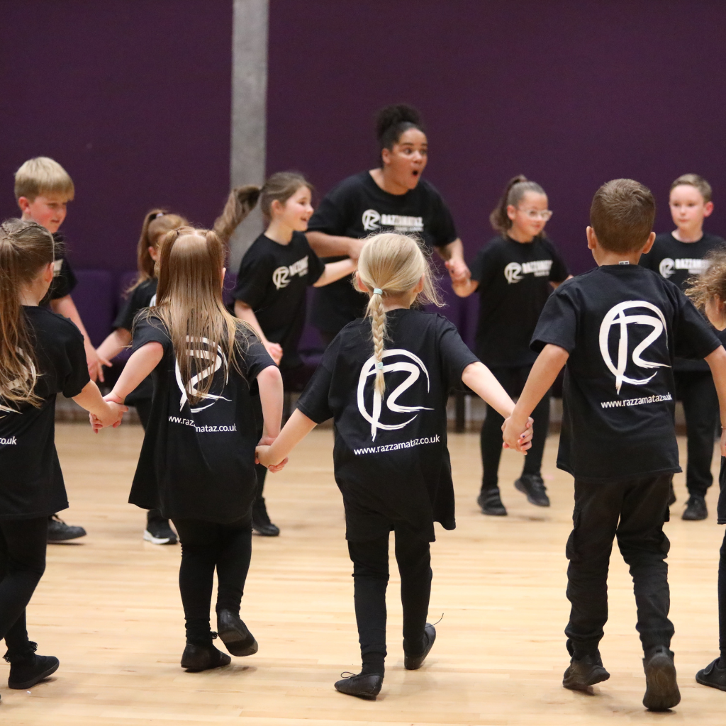 adults and children stood in a circle